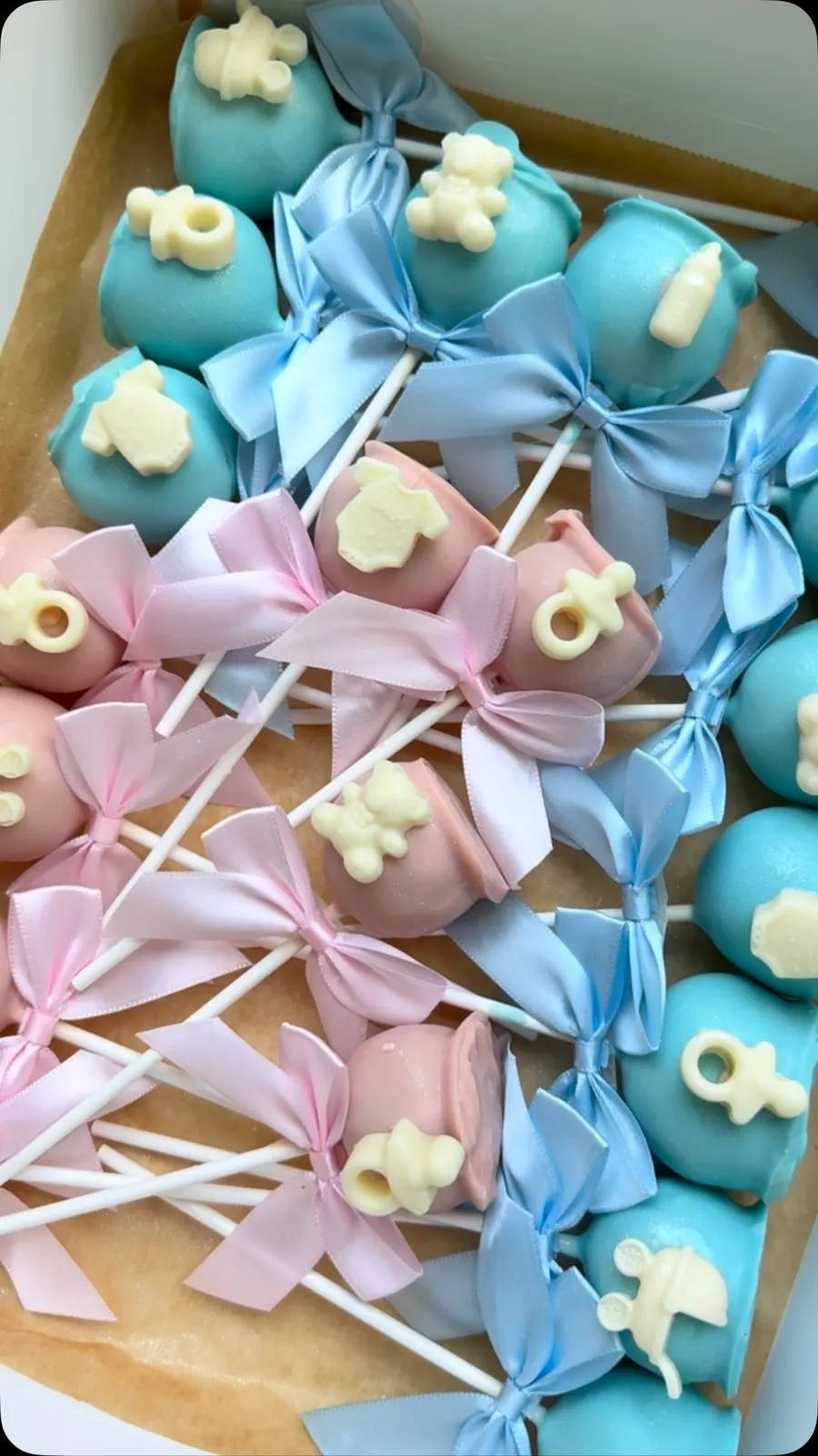 Pink and blue baby shower cake pops with bows