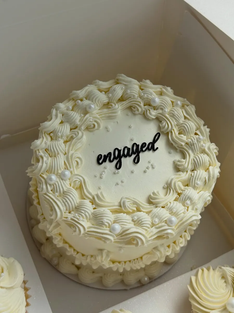 Cream "engaged" bento cake with matching cupcakes