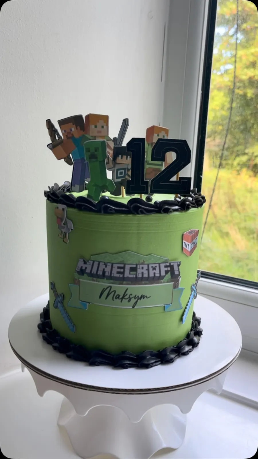 Green Minecraft birthday cake with character toppers and a 12