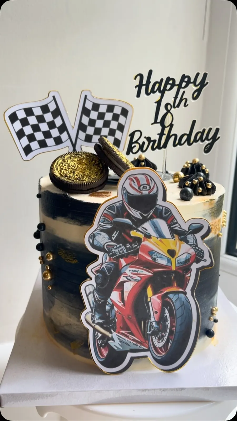 Racing motorbike first birthday cake with chequered flags