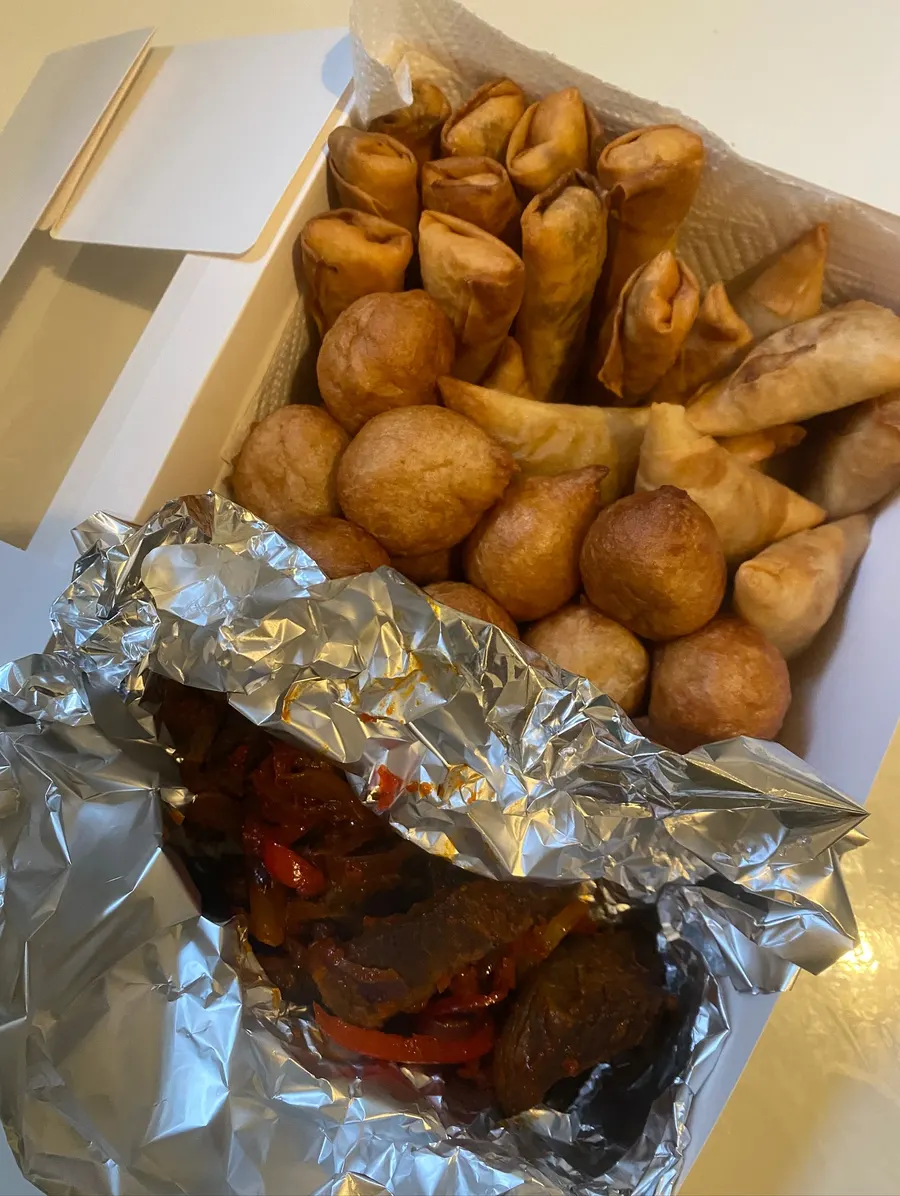 Small chops platter with puff puff, spring rolls and peppered meat